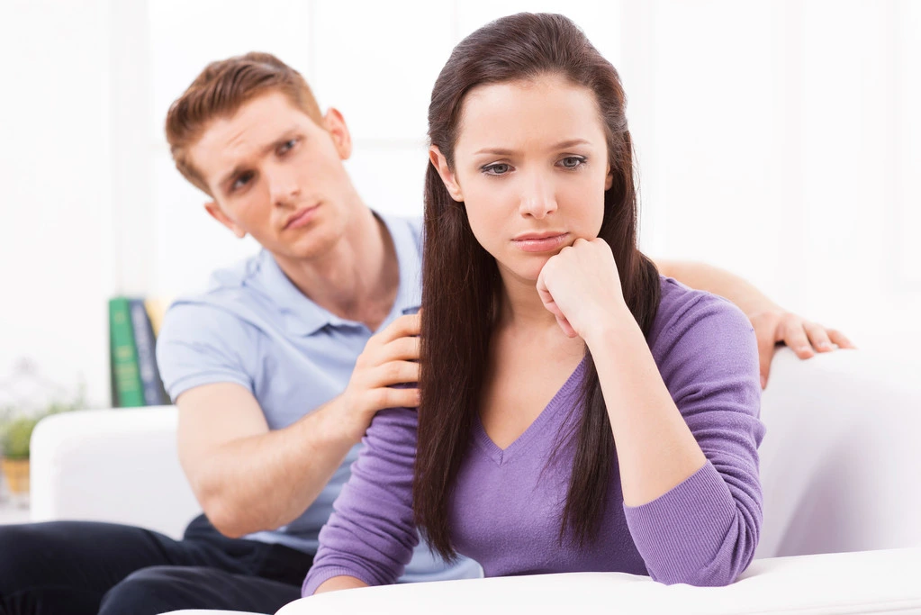 13 Relationship Issues, How To Avoid Them and Solutions 7 Leave me alone! Young man trying to comfort his depressed girlfriend sitting close to him on the couch