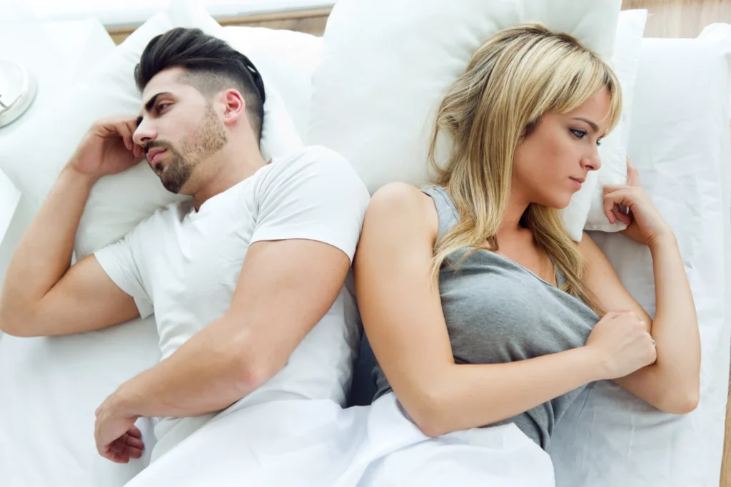 13 Relationship Issues, How To Avoid Them and Solutions 6 upset couple lying back to back in bed due to relationship issues