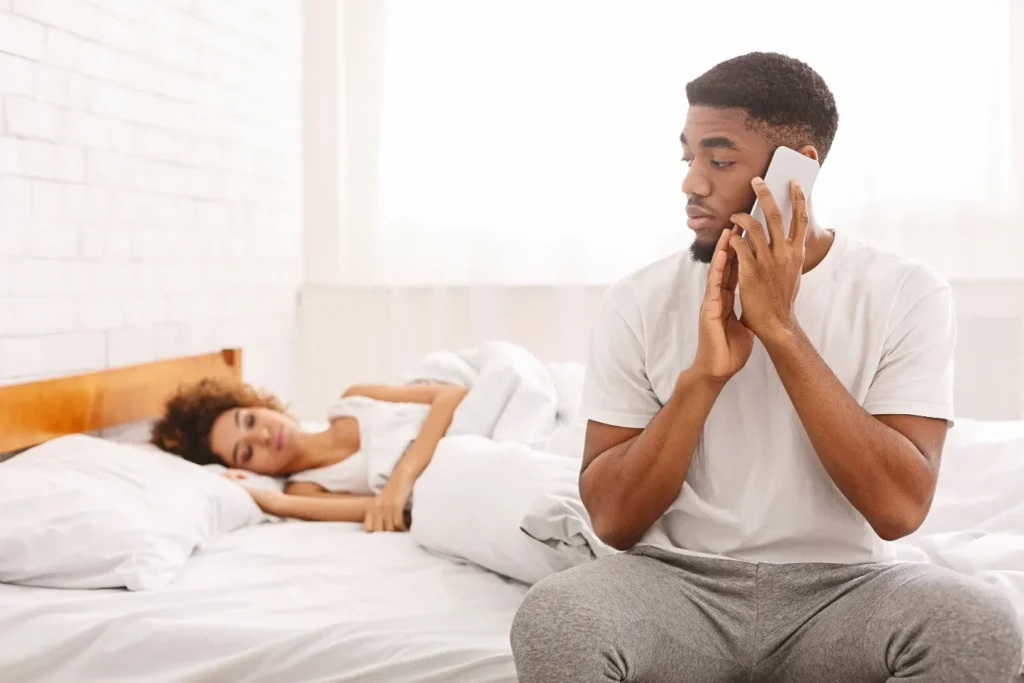 How to choose the right life partner in a love triangle? 3 A man making a phone call while the girlfriend is sleeping